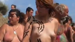 8. Nudists getting body painted (quite a few have bush!)