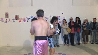 3. Topless woman spars with a male boxer in “PAOLO BIELLI (RING) VIOLET-RING”