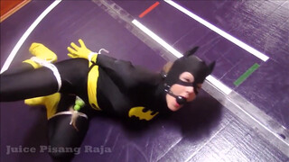 Batgirl is tied up and strapped to a vibrator in “Recent Bondage Latek Girl Orgasm On Catsuit”