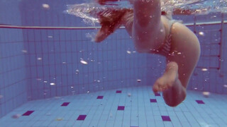 swimming girl under water, flashes on time stamp and at 55 seconds