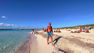 5. Topless woman on beach walk in Ibiza