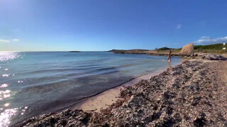 8. Topless woman on beach walk in Ibiza