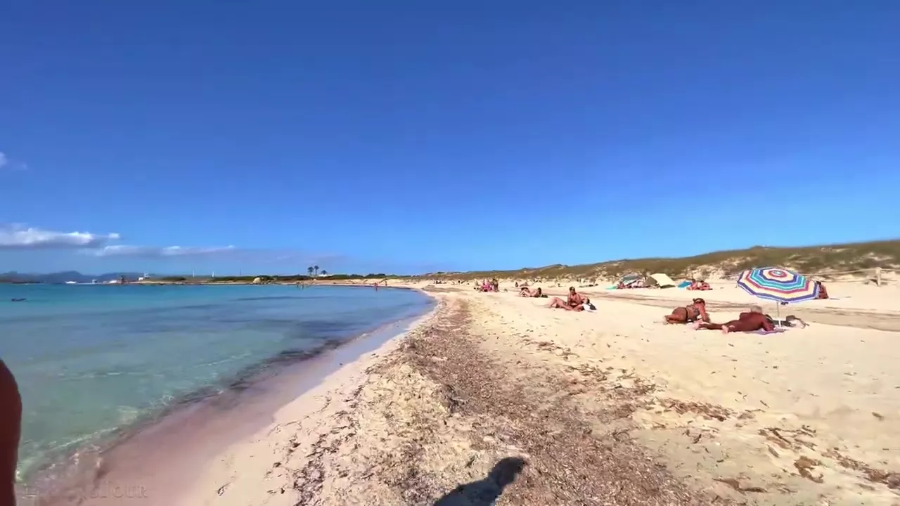 Topless woman on beach walk in Ibiza | Nude Video on YouTube | nudeleted.com