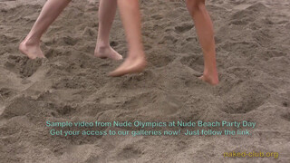 8. Two naked guys are “Wrestling clothing-free at a beach festival”. Also, topless photographer’s boobs are visible in the background