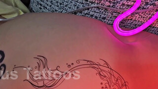 9. Bare ass visible while putting on a temporary tatoo on a butt cheek