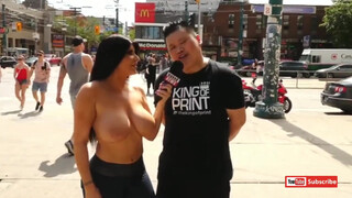 6. Topless pornstar Romi rain in public. I can see some kids in the crowd