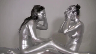 6. These girls seem to be enjoying painting each others bodies silver