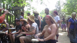4. Beating the Bongo and Bouncy Breasts. Drum circle with topless hippy drummer free spirit