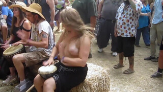 1. Beating the Bongo and Bouncy Breasts. Drum circle with topless hippy drummer free spirit