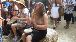 8. Beating the Bongo and Bouncy Breasts. Drum circle with topless hippy drummer free spirit