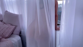 1. Anna Azerli behind a sheer curtain