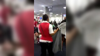 2. Black woman walking naked in airport (nude throughout)