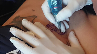 4. Tattoo above a shaved, pierced pussy (“Spesa one – Logo Tattoo Muschi”)