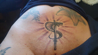 9. Tattoo above a shaved, pierced pussy (“Spesa one – Logo Tattoo Muschi”)