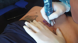 3. Tattoo above a shaved, pierced pussy (“Spesa one – Logo Tattoo Muschi”)